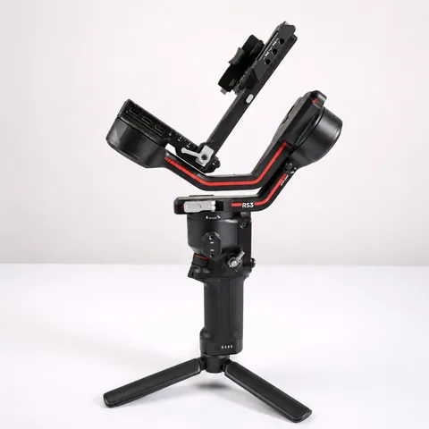 Used DJI RS 3 gimbal standing on its tripod grip